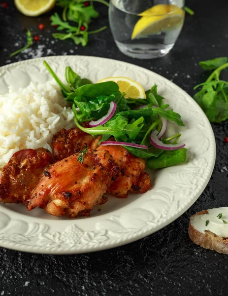 Roasted boneless skinless chicken thighs with rice and green vegetables mix