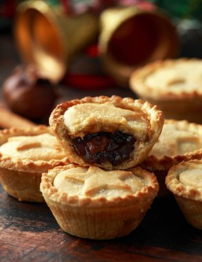 İngiliz Noel kıymalı börek dekorasyon, hediyeler, ahşap rustik masa üzerinde yeşil ağaç dalı ile