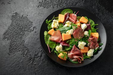 Parma salata mozzarella peyniri ile jambon ve kavun, yeşil yaprakları karışımı
