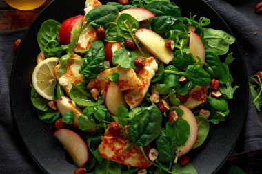 Grilled Halloumi Cheese salad with peach fruit, nuts and spinach, arugula mix. healthy food. clipart