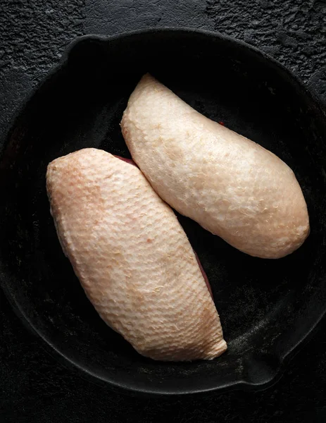 Raw duck brest fillets on rustic cast iron pan, skillet — Stock Photo, Image