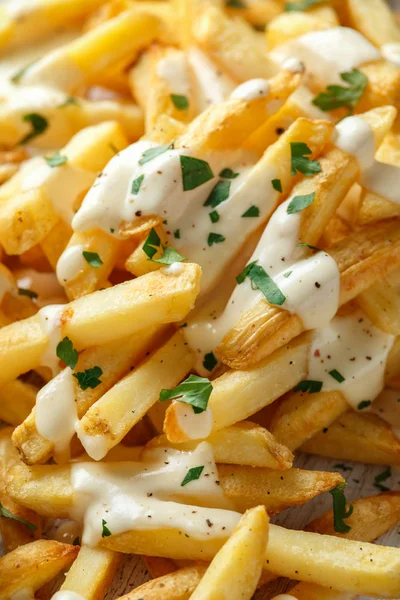 Homemade Baked Potato Fries with cheese sauce on white wooden board. closeup — Stock Photo, Image
