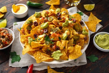 Meksika Nacho tortilla cips zeytin, jalapeno, guacamole, domates salsa ve peynir sos ile.