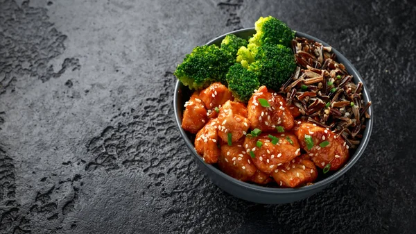 Teriyaki chicken, steamed broccoli and wild rice served in bowl