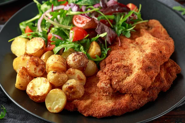 Homemade breaded pork schnitzel with roast potato and vegetables — Stock Photo, Image