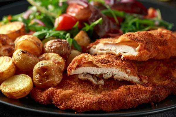 Homemade breaded pork schnitzel with roast potato and vegetables — Stock Photo, Image