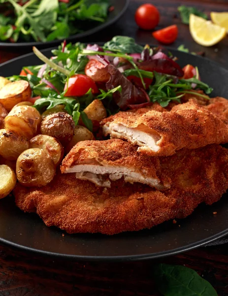 Homemade breaded pork schnitzel with roast potato and vegetables — Stock Photo, Image