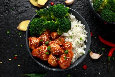 Teriyaki tavuk, haşlanmış brokoli ve basmati pirinç iki Asya kil kase içinde servis