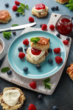 Classic scones with clotted cream, strawberries jam, english Tea and other fruit clipart