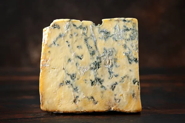 English Blue cheese stilton on rustic wooden background