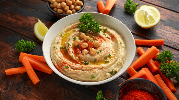 Hummus with olive oil, paprika, lemon and carrot.