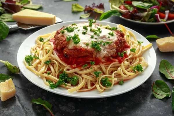 Chicken Parmesan with Cheese and Marinara Sauce served over spaghetti, pasta