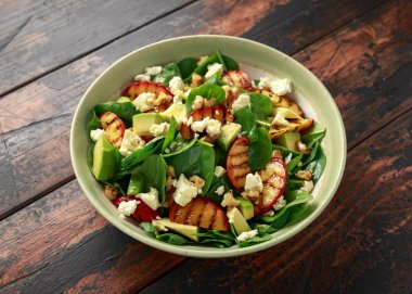 Rustik kasede ıspanak, avokado, ceviz ve beyaz peynirli Yaz Şeftali Salatası. sağlıklı gıda.