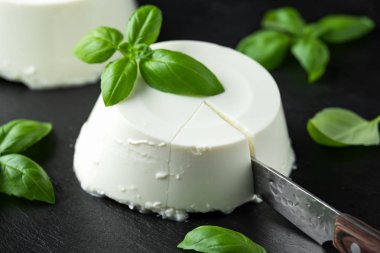 Siyah rustik masada fesleğen yaprağı ile taze Ricotta peyniri. seçilen odak