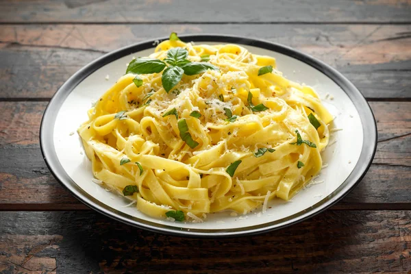 Pasta al Limone, Lemon with basil and parmesan cheese on wooden table Stock Picture