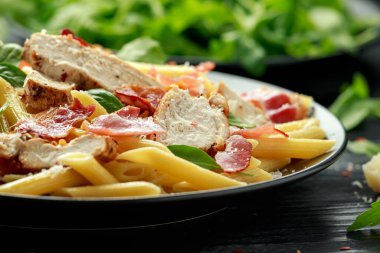 Tavuk, pastırmalı makarna, parmesan peynirli ve fesleğenli. sağlıklı yiyecekler.