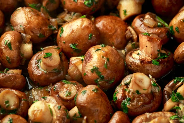 Demir tavada soğanlı ve sarımsaklı kızarmış mantar.