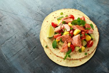 Mango, avokado, domates, taze soğan ve limonlu somon balıklı taco. Meksika yemeği