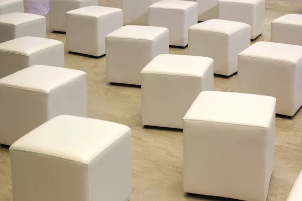 pile of white leather chair on marble floor