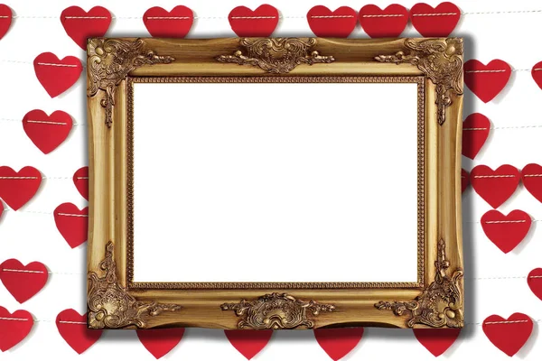 photo of golden picture frame with red paper heart background