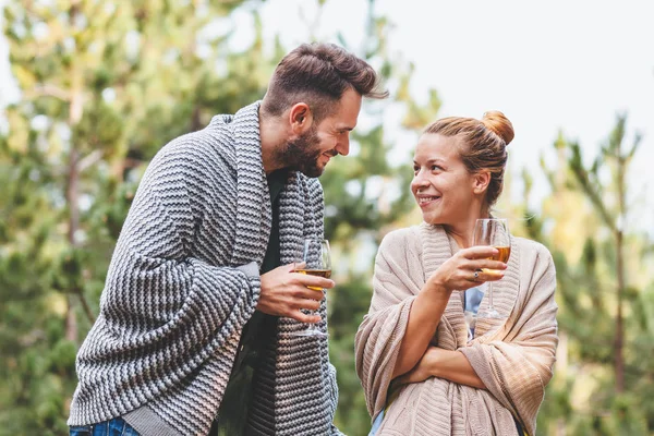 Young couple flirting on the balcony drinking white wine