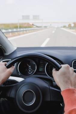 Young man driving a car, interior shot