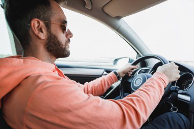 Young man driving a car, interior shot