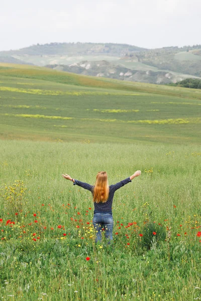 Young Woman Standing Field Wild Flowers Arms Stretched Out — Stockfoto