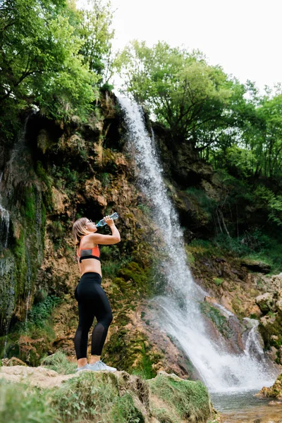 Young Female Nature Explorer Drinking Water Waterfall — Stock Photo, Image
