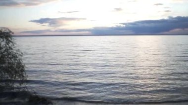 Akşam vakti ormanda gün batımı, nehrin yanındaki ormanda çadırlar, turistler için yeşil çadırlar hazır, akşam güneşi, turistler dinleniyor.