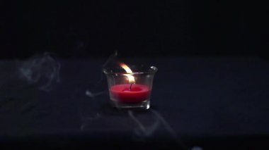 Güzel bir mum yanar ve su damlası onu yavaş çekimde söndürür.