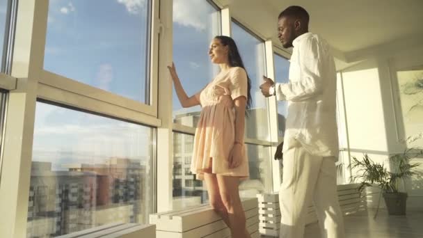 Handsome Black Guy Hugging Beautiful Fair Skinned Girl Sitting Windowsill — Stock Video