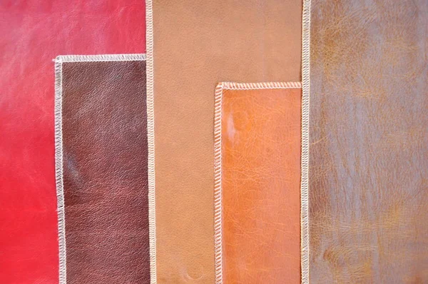 Multicolored sheets of leather stacked on top of each other.