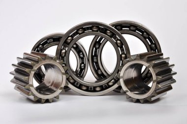 Gears and three roller bearings on a white background. Part of the car's