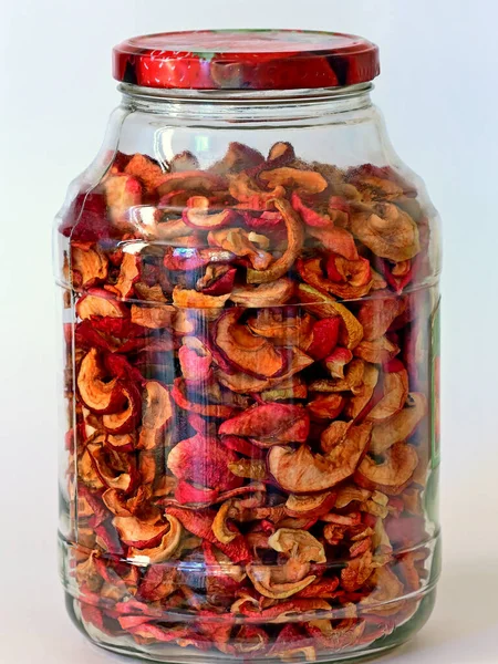Dried fruits (apples) made at home and stored for the winter in a glass jar. On white background. — Stock Image Dried Fruits Apples Made Home Stored Winter Glass Jar White Stock Picture