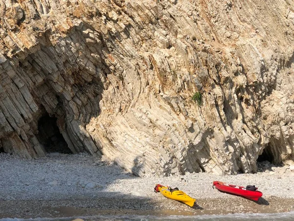 Canots jaunes et rouges sur l'eau, attachés au rivage. — Photo