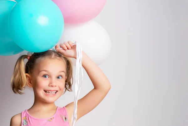 Beautiful little girl and bright balloons — Stock Photo, Image