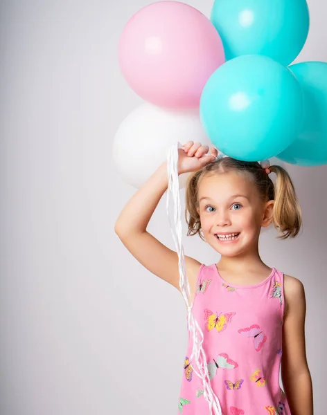 Beautiful little girl and bright balloons — Stock Photo, Image