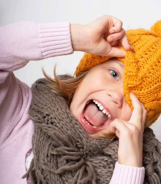 Close up face portrait of toothy smiling young woman wearing knitted  hat and scarf. — Stock Photo, Image