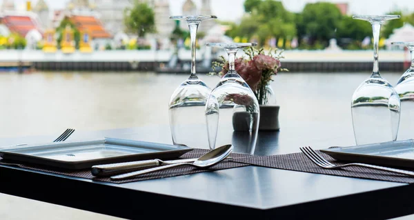 picture of table in restaurant with the view of river from wide window