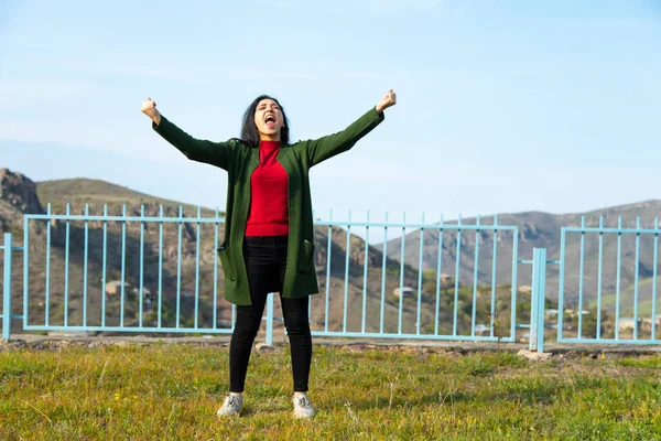 happy woman in mountain under sky background