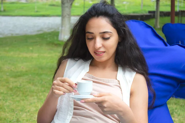 woman hand cup of coffee in garden cafe