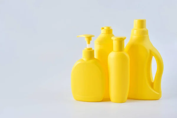Four Yellow Plastic Bottles White Background Right Side — Stock Photo, Image