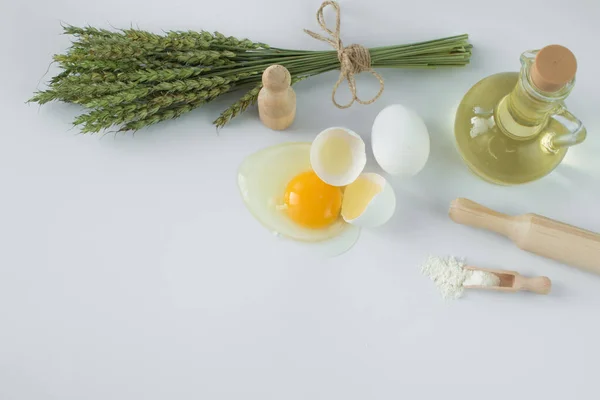 Composition of natural products. Cooking products: butter, egg, flour. Flatlay, top view overhead flatly flat lay