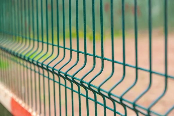 Mesh fence. Metal fence made of welded mesh.