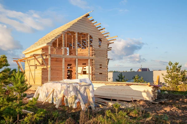 Construction of a house made of laminated veneer lumber. The frame of the house. Cottage made of laminated wood. Erection of the frame of the cottage.