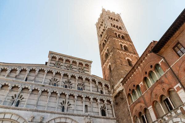 Romanesque Facade and bell tower of St. Martin Cathedral in Lucca, Tuscany, Italy