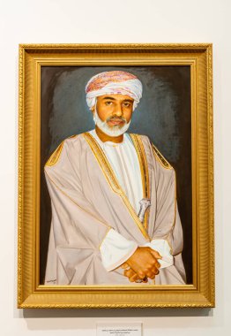 Muscat, Oman - February 10, 2020: Portrait of his Majesty Sultan Qaboos inside of the Bait Al Zubair Museum in old Muscat od Sultanate of Oman clipart