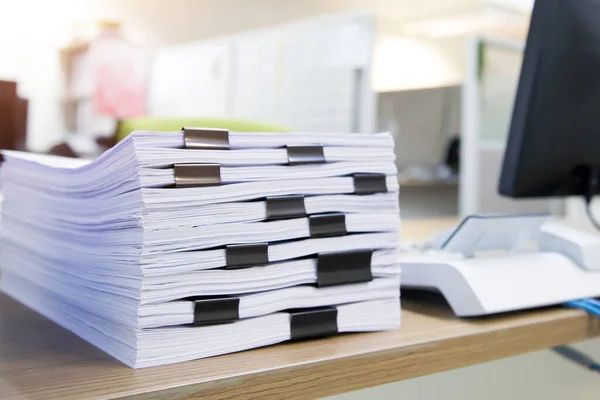 Pile of a lots paper and paperwork report or printout document on desk office stack up for work hard and information concepts.