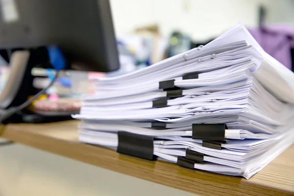 Pile of a lot papers documents on desk office stack up.